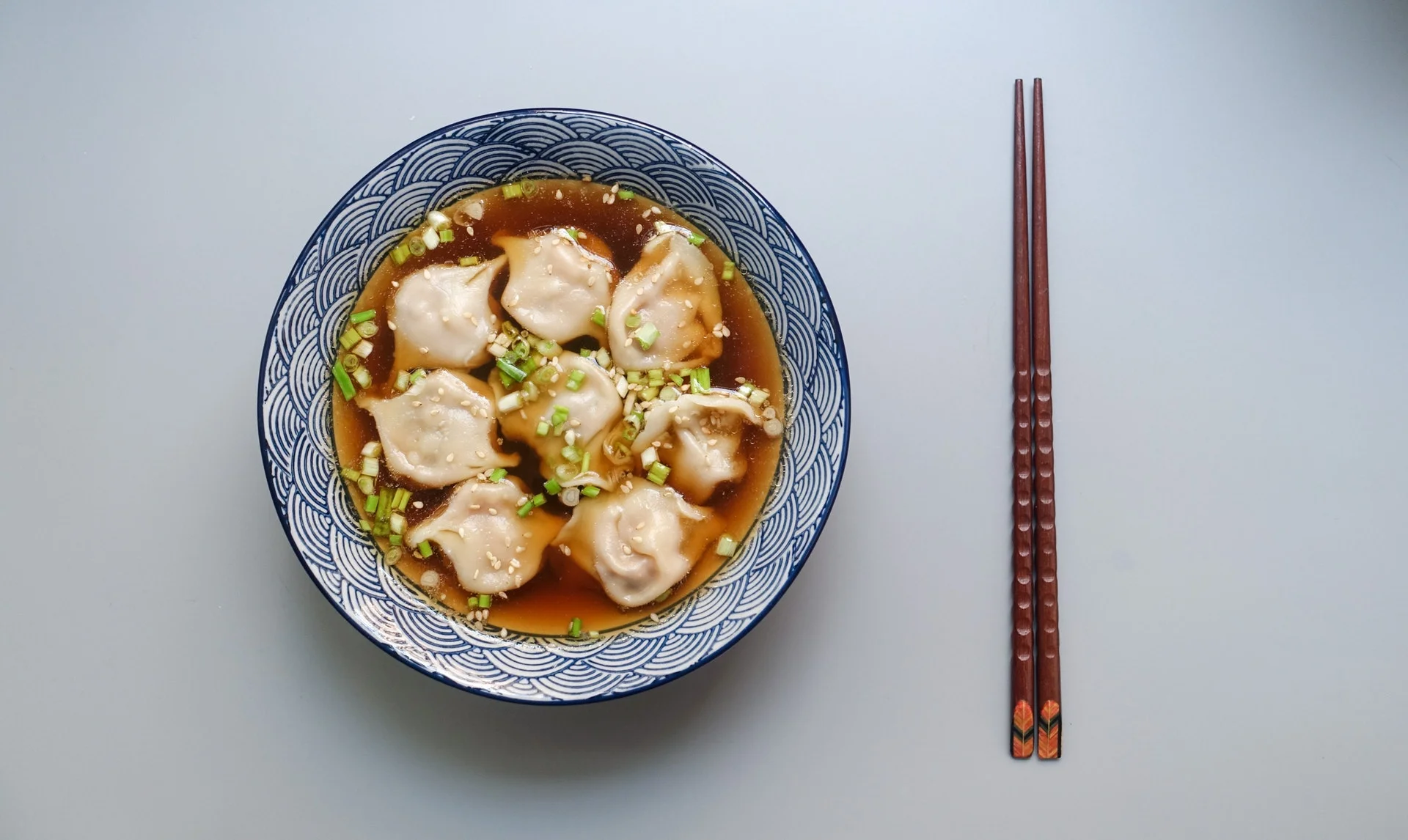 Momo dumpling soup served with chopsticks